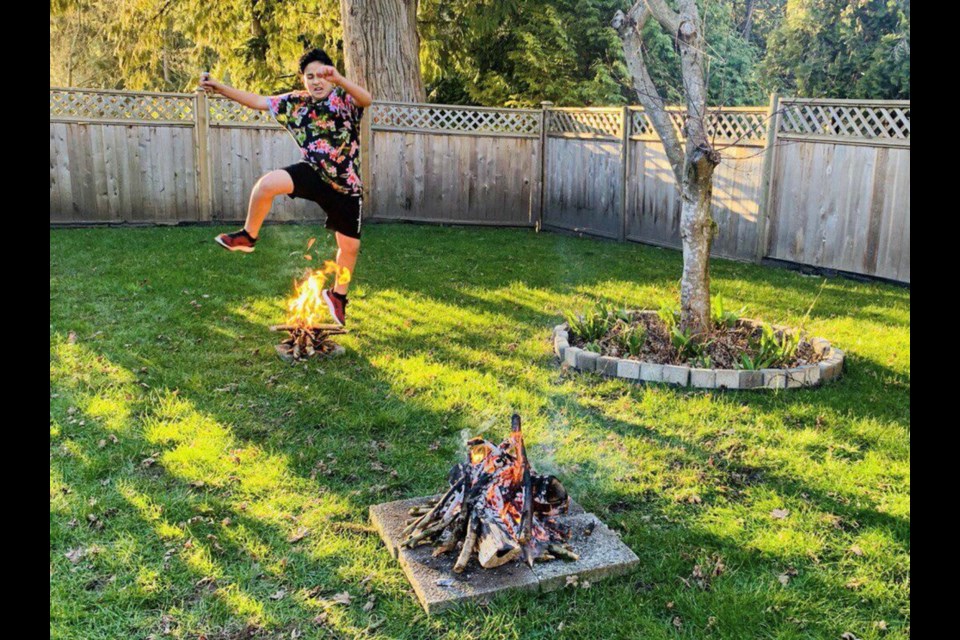 Majid Davoudi, 14, jumps over a fire at his home in North Vancouver. The practice honours nature, celebrates the rejuvenation of spring and is meant to cleanse the jumper of bad habits, says Coquitlam friend of the Davoudi family Behzad Abdi.
