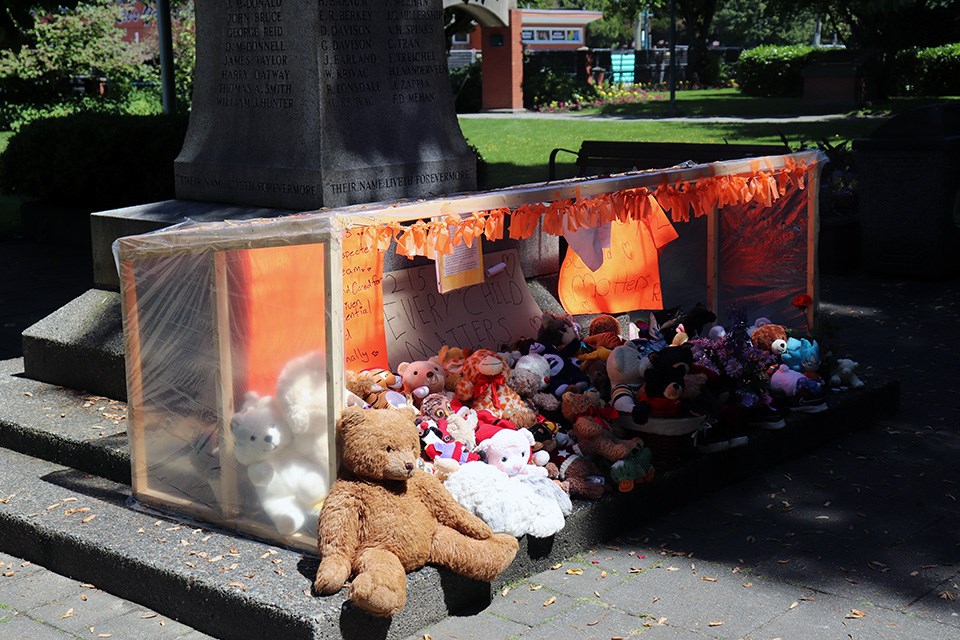 A vigil in Port Coquitlam's Veteran Park honours the 215 children found in unmarked graves at a former Kamloops residential school with teddy bears, stuffed animals, shoes and notes from local residents.