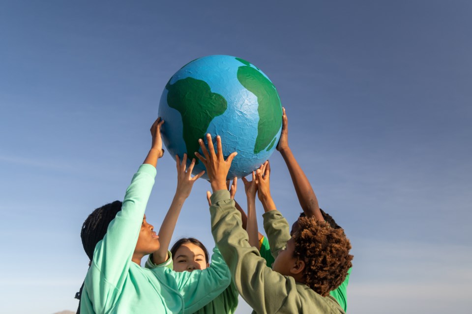 getty-images-children-hold-up-the-planet