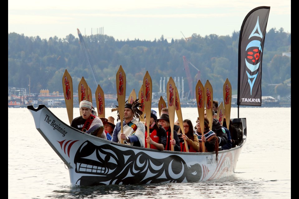  A Coast Salish canoe arrives at Belcarra Regional Park carrying Tsleil-Waututh dignitaries and Metro Vancouver officials for a ceremony to rename the park tÉmtÉmÃ­xÊ·tÉn.
