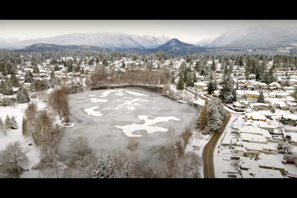 Beautiful drone shot of Como Lake Park in Coquitlam during winter freeze-up.