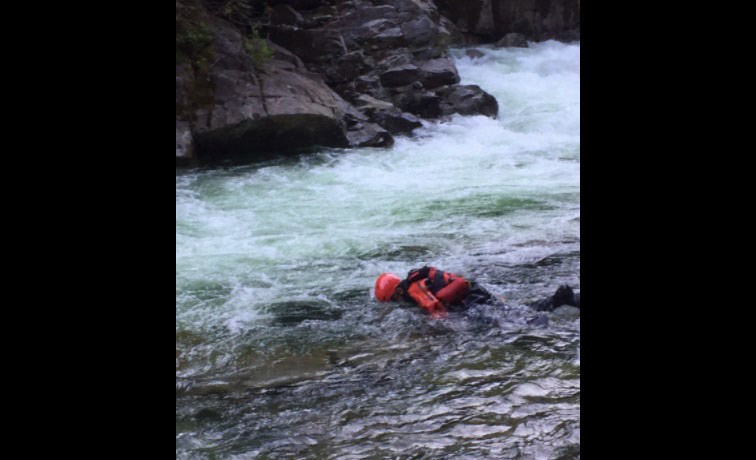 A member of Coquitlam Search and Rescue's swiftwater team searches a pool during a rescue effort at Widgeon Falls on June 21, 2021.