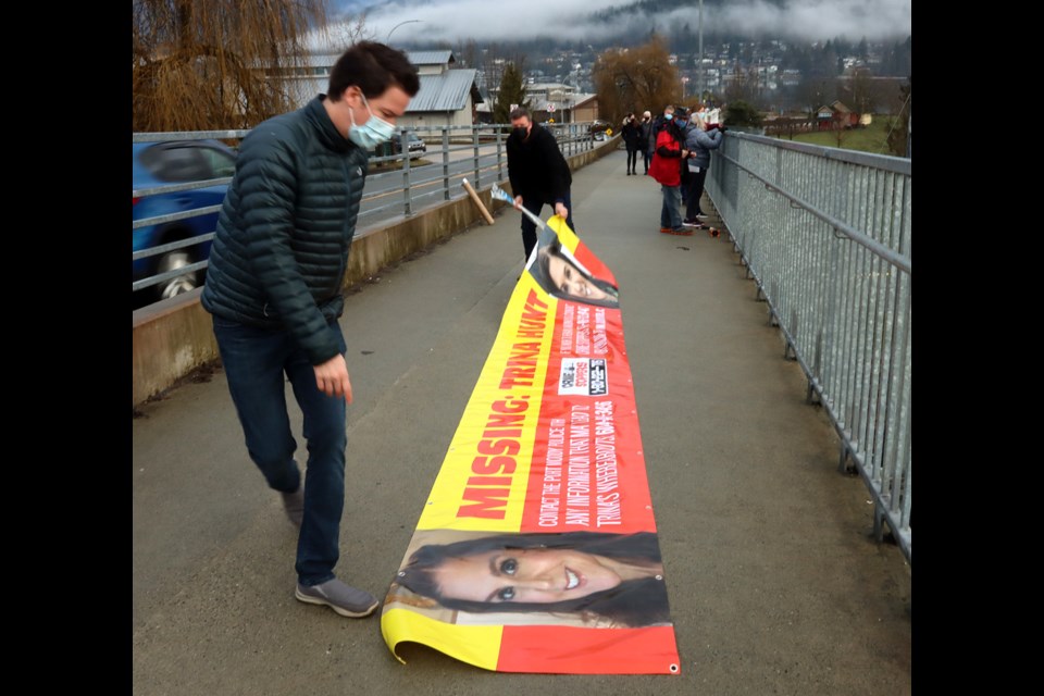 Family members of Trina Hunt prepare to hand a banner from the Moody Street overpass at Rocky Point Park as they continue to search for her after she disappeared from her Port Moody home on Jan. 18.
