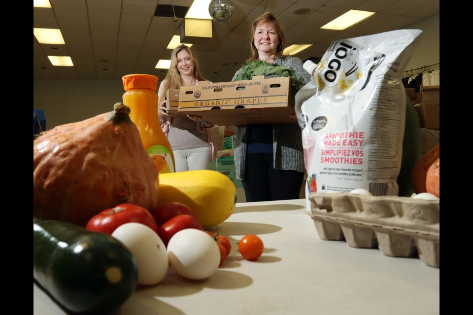 Pam Eberl and Kristie de Jong administer the People's Pantry that distributes fresh produce and perishables like milk, eggs, juice and meat that have been deemed unsellable by grocery stores.