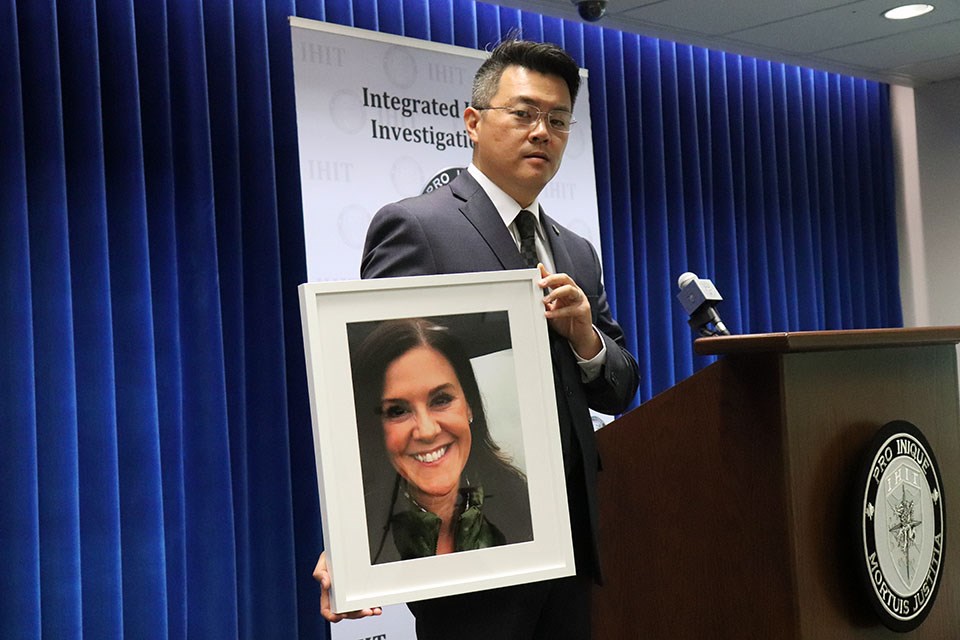 Integrated Homicide Investigation Team (IHIT) spokesperson Sgt. Frank Jang holds up a picture of Trina Hunt on behalf of the family on June 1, 2021, as the Port Moody woman's murder is still under investigation.