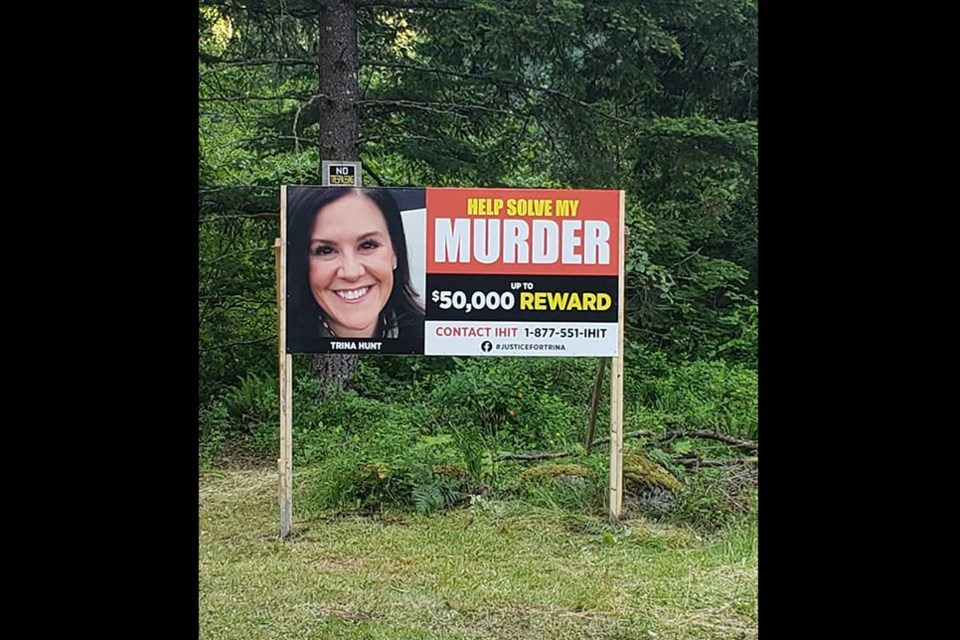 A large sign asking passersby to call for information on Trina Hunt's murder has been placed in the Silver Creek area south of Hope where the Port Moody woman's body was found on March 29, 2021.