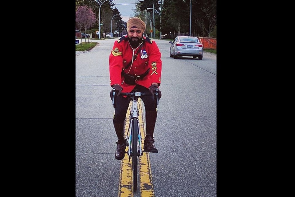 Coquitlam RCMP Cpl. Ranjit Seehra mounts a bike as part of his detachment's 2021 Cops for Cancer initiative.
