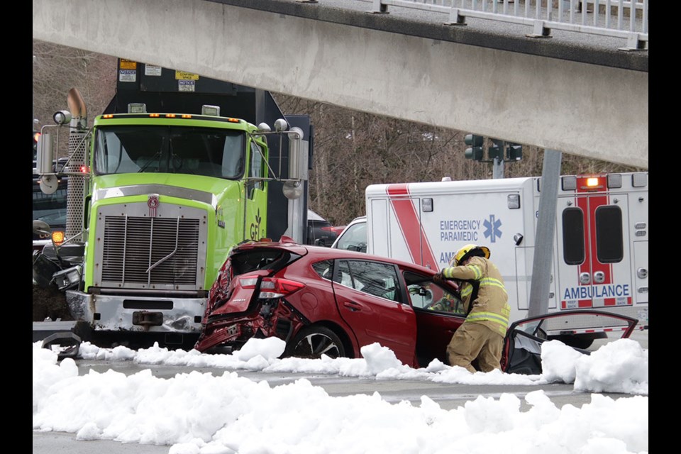 The driver of a four-door sedan was taken to hospital with minor injuries after a collision with a dump truck in Coquitlam on March 2, 2023.