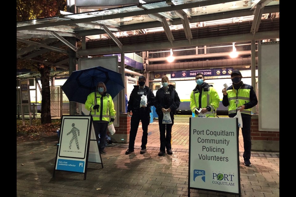 Transit police and members of its community engagement team hand out reflectors at Coquitlam and Port Coquitlam transit hubs as part of its 2021 pedestrian safety awareness campaign.