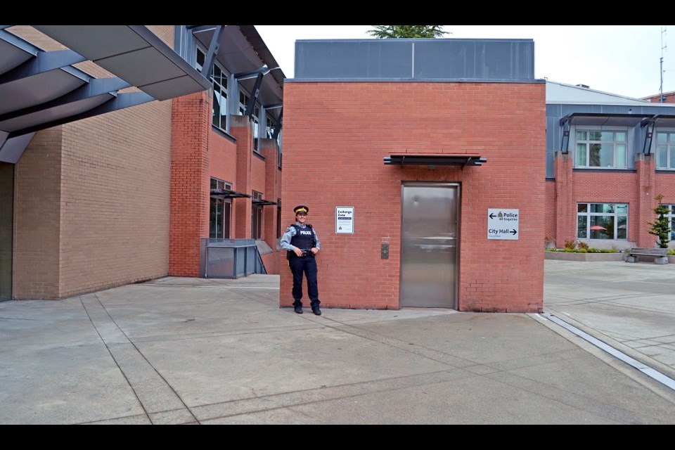 Coquitlam RCMP Cpl. Alexa Hodgins stands in the detachment's new exchange zone where residents can arrange to meet with online buyers in a safe surveyed area.