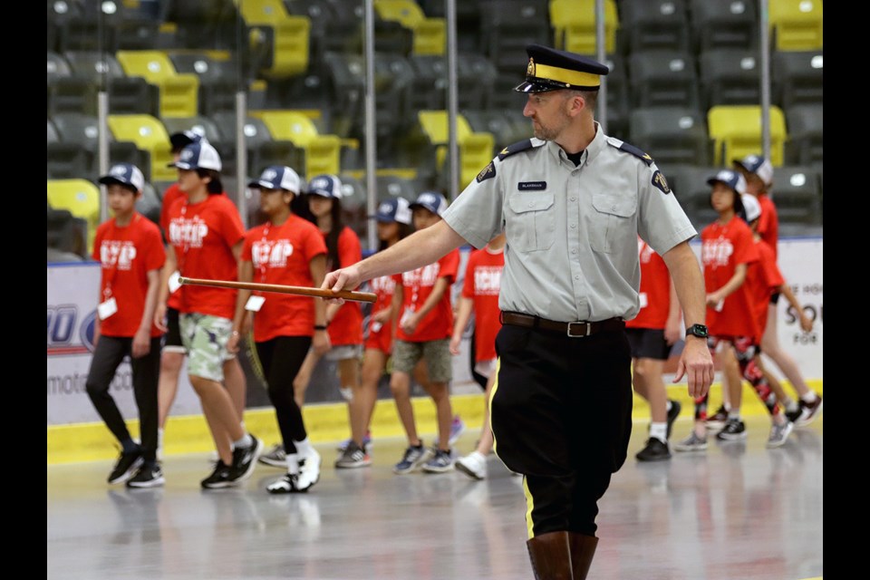 Cpl. Andrew Blakeman, of Coquitlam RCMP, tries to keep the ranks in order during drill instruction at Jr. Mounties camp, Thursday at the Poirier Sport and Leisure Complex.