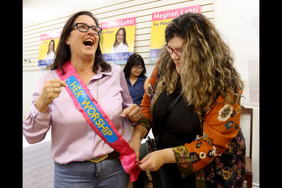 Port Moody's new mayor-elect, Meghan Lahti, is presented with a ceremonial sash during a celebration at her campaign headquarters on Saturday.