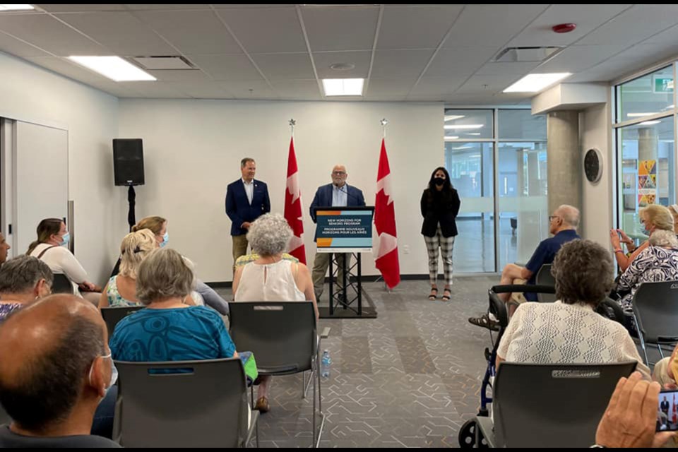 Coquitlam-Port Coquitlam MP Ron McKinnon (at podium) joined Canada's Minister of Seniors Kamal Khera to announce nearly $68,000 in grant funding for three Tri-Cities seniors programs.