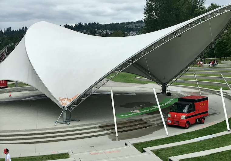 Workers clean up 'Cancel Canada Day' graffiti at the TD Plaza in Town Centre Park in Coquitlam.