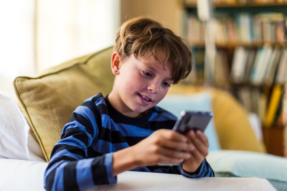 young-boy-playing-with-a-cell-phone