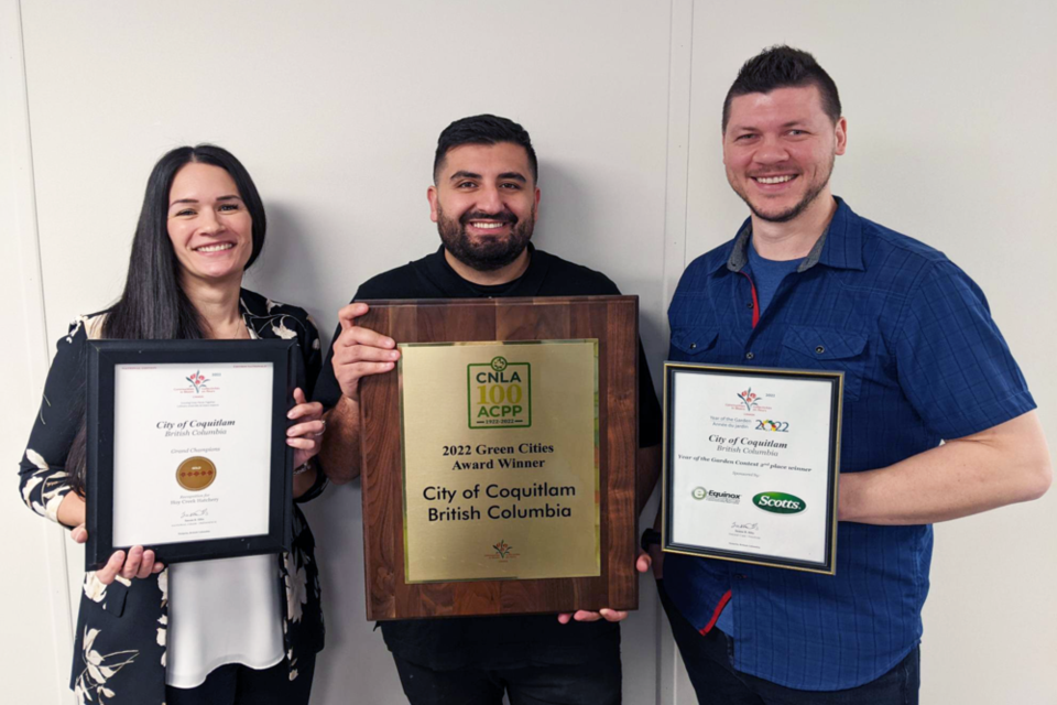 Park Services Manager Sarah Yastremski stands on the left-hand side of the image with two of her colleagues holding up their Communities in Bloom award plaques.