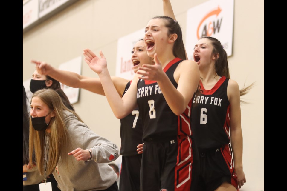 Terry Fox Ravens players celebrate the team's 83-76 win over the Okanagan-Mission Huskies in their semifinal game at the BC High School girls AAAA basketball championships on March 4, 2022, at the Langley Events Centre. Fox will face crosstown rivals, the Riverside Rapids, in March 5 championship final.