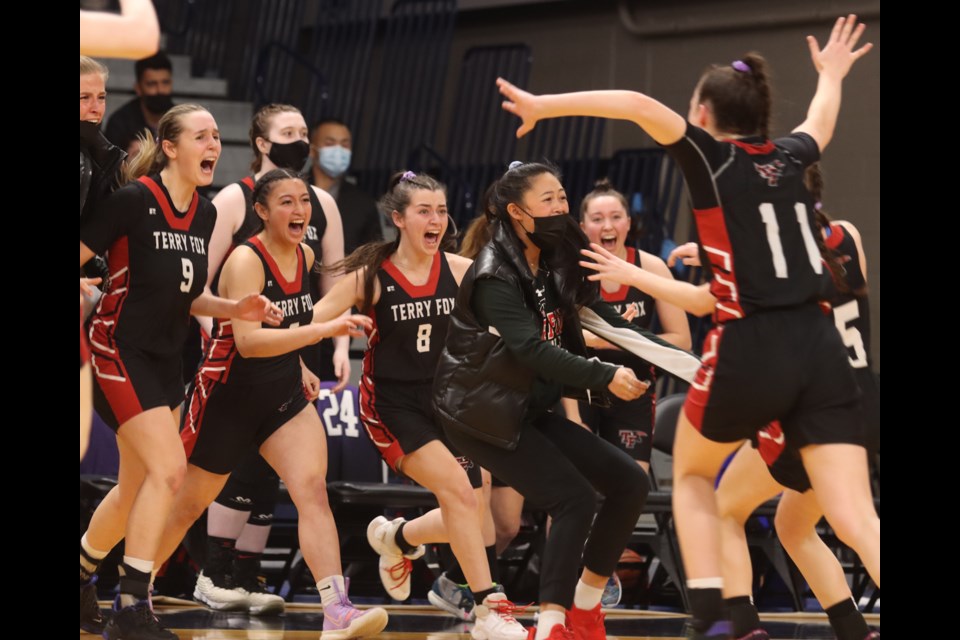 The Terry Rox Ravens charge off the bench to celebrate the team's 77-75 win over the crosstown Riverside Rapids to claim the BC High School AAAA girls basketball championship on March 5, 2022, at the Langley Events Centre.