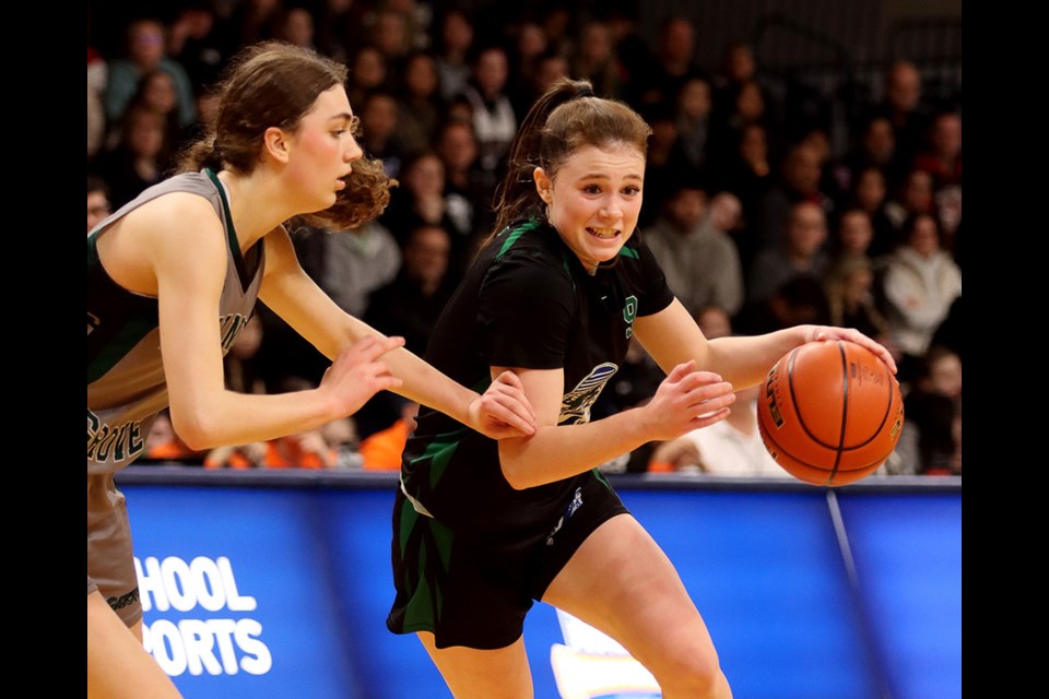 Riverside Rapids guard Avery Sussex (#9) drives hard to the basket around a Walnut Grove Gators defender in the first half of their 2023 B.C. AAAA girls' high school basketball championship game on March 4 at the Langley Events Centre.