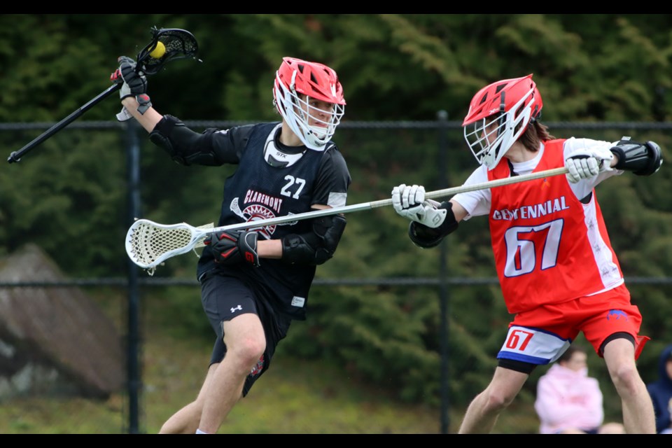 Centennial Centaurs defender Tannery Hayden checks Claremont's Dorion Connelly in the first half of their game at the BC High School field lacrosse provincial championships, Wednesday at Coquitlam Town Centre. Centennial won the game, 7-3.
