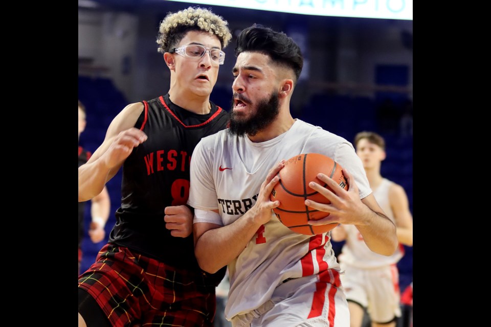 Terry Fox Ravens guard Sukhraj Garcha drives past West Vancouver Highlanders guard Zayed Ahmed in the first half of their opening round game at the BC High School AAAA boys basketball championships, Wednesday at th Langley Events Centre. Fox won 70-45 to advance to the quarter-finals on Thursday.