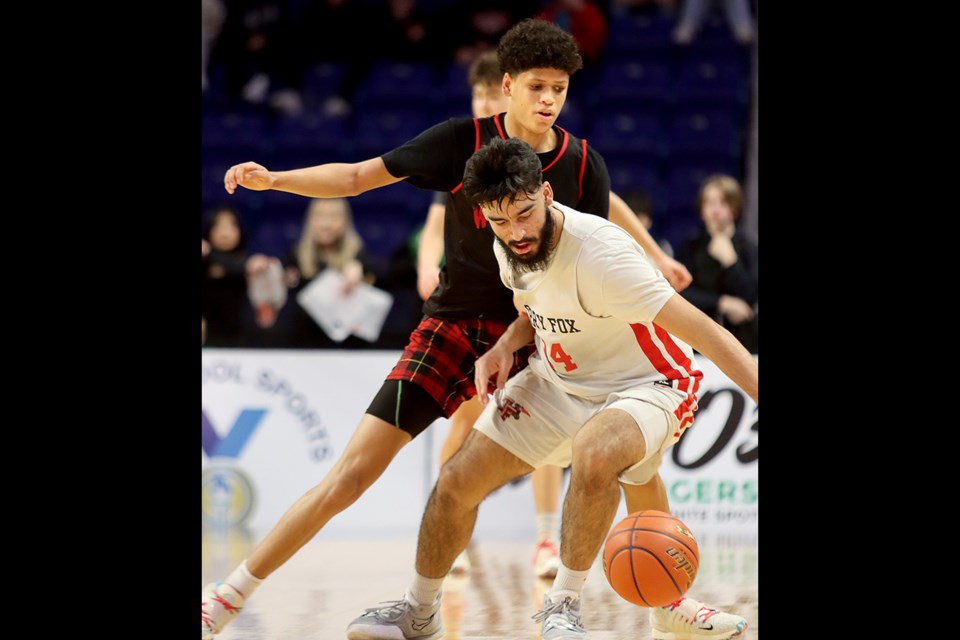 Terry Fox Ravens guard Sukhraj Garcha battles for control of the ball under pressure from West Vancouver Highlanders guard Radin Thiel in the first half of their opening round game at the BC High School AAAA boys basketball championships, Wednesday at the Langley Events Centre.
