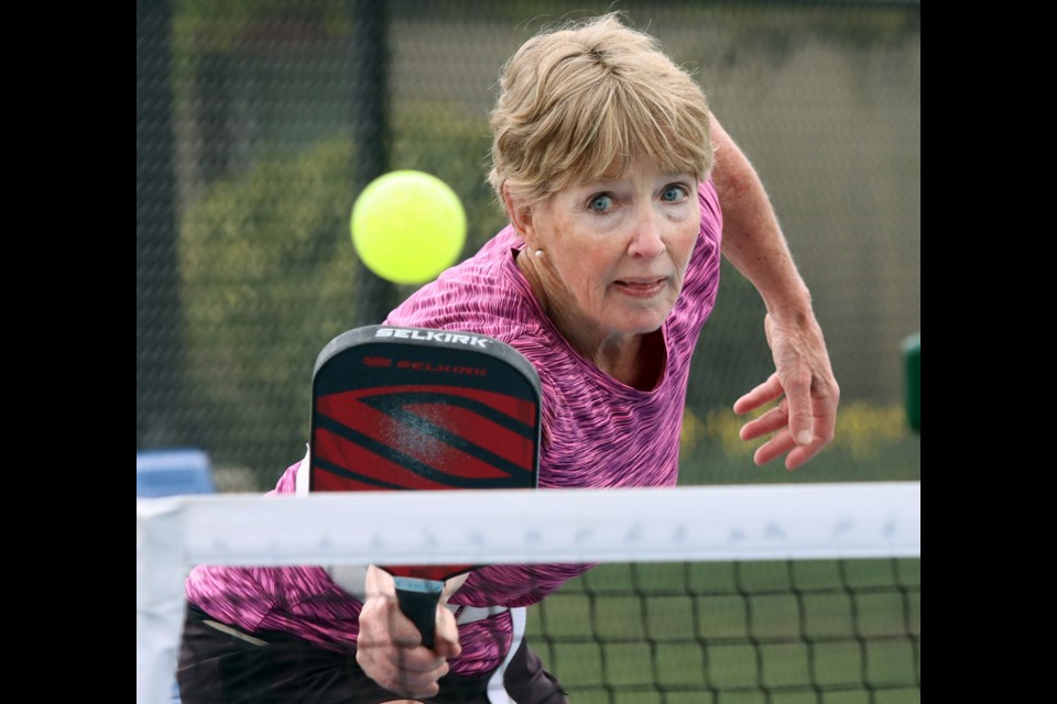 A story about the demand for pickleball facilities needed a pickleball photo. And while it might be easy to dismiss the sport for its odd name, its players take it very seriously.
 Brenda Martel returns a volley during a pickleball match at the courts near Dogwood Pavillion in Coquitlam on Friday.