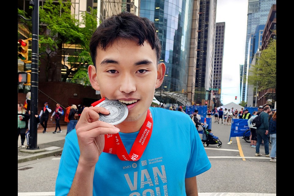 Coquitlam's Paxton Lin celebrates his fourth-place finish in the Men's 19 age category at Sunday's BMO Vancouver Marathon.
