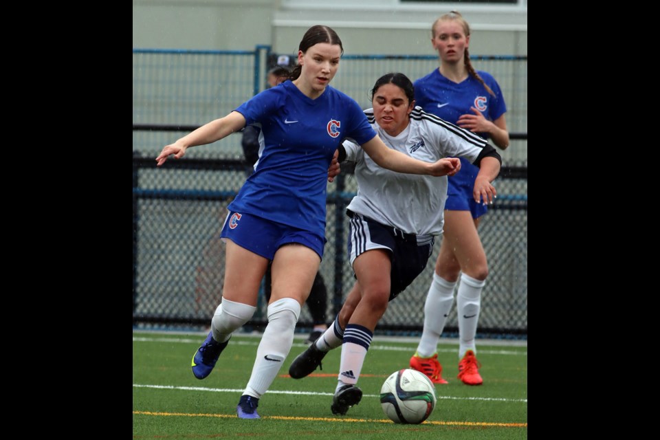 Ava Ferreira of the Centennial Centaurs tries to escape the marking of Riverside Rapids defender Narissa Gillani in the first half of their Fraser North senior girls soccer playoff match, Thursday at the Centennial turf field. The Centaurs won, 2-0.