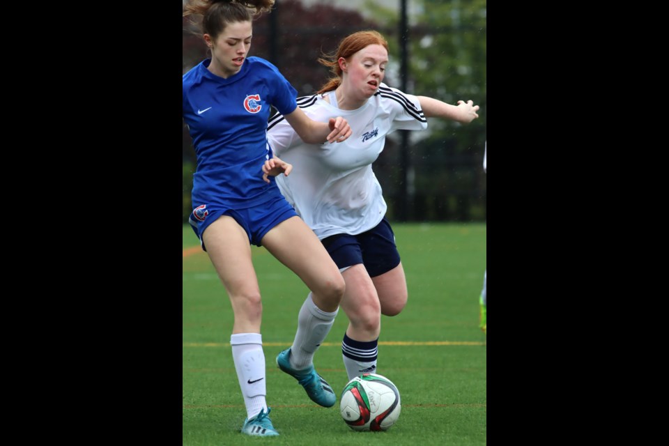 Alexa Cardarelli of the Centennial Centaurs and Cassie Robinson of the Riverside Rapids battle for control of the ball in the first half of their Fraser North senior girls high school soccer match, Thursday at the Centennial turf field. The Centaurs won 2-0.
