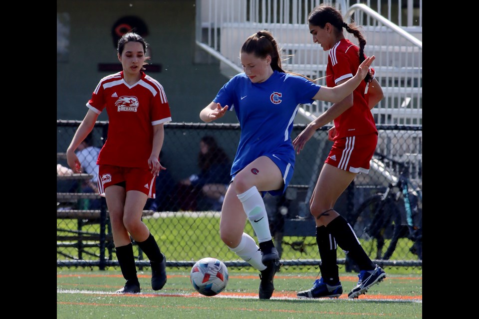 Centennial Centaur forward Ava Ferriera tries to split the Fraser Heights Firehawks defence in the second half of their group play match Thursday at the AAA high school girls soccer provincials at the Cloverdale Athletic Centre. Fraser Heights won, 2-1.