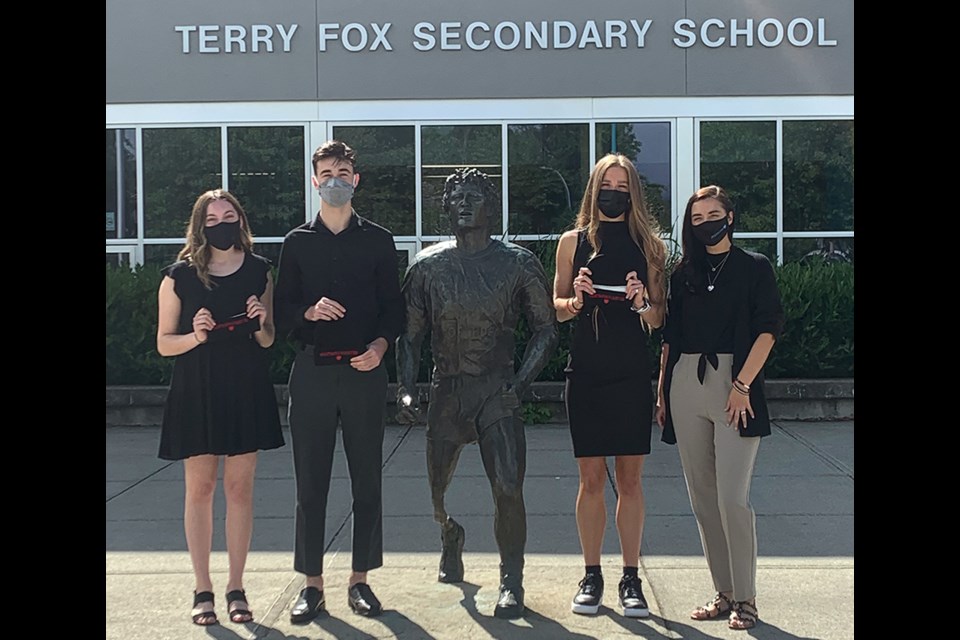 Terry Fox graduates (l-r) Julia Watkins, Jake Lewis and Chelan Slater receive their bursary awards from Jen Kuong, the mother of Karin Khuong, a basketball player for the Ravens senior girls team who lost a two-year battle with cancer last October.