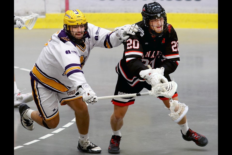 Coquitlam Adanacs Dylan Watson tries to knock the ball from the stick of Nanaimo Timbermens Kris Veltmen in the first period of their opening game in the Western Lacrosse Association's best-of-seven semifinal, Saturday at the Poirier Sport and Leisure Complex.