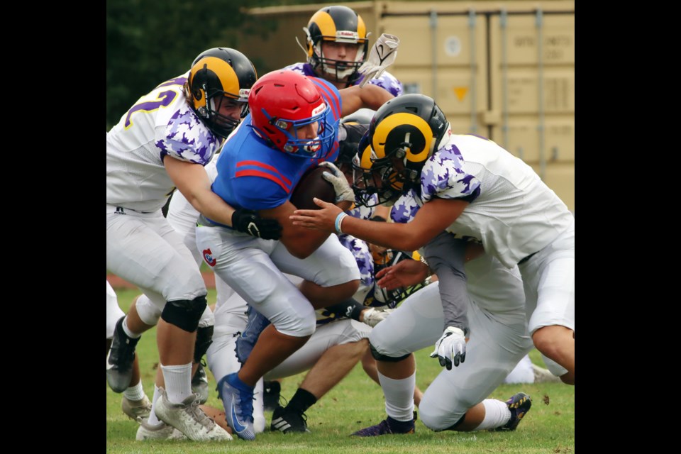 MARIO BARTEL/THE TRI-CITY NEWSCentennial Centaurs running back Ziad Sabry is swarmed by Mt.Douglas Rams tacklers in the first quarter of theri BC High School Football varsity exhibition game, Friday at Centennial. Mt. Douglas won the game, 19-13. It was the first competitive game in almost two years for both sides because of COVID-19 public health restrictions that limited players to practising.