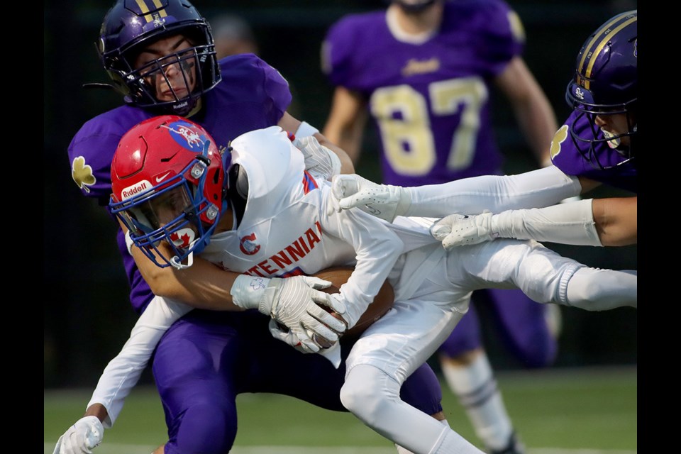 Centennial Centaurs ball carrier Sha'an Luddu lunges for extra yardage in the team's home opener against the Vancouver College Fighting Irish on Sept. 16, 2022, at Centennial Secondary School's new turf field.