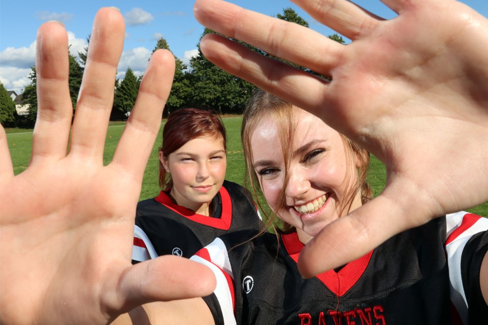 Kali McCready (right) and Robin Rothwell are each taking on a new challenge as the seniors are playing wide receiver for the Terry Fox Ravens. Neither has played football before.