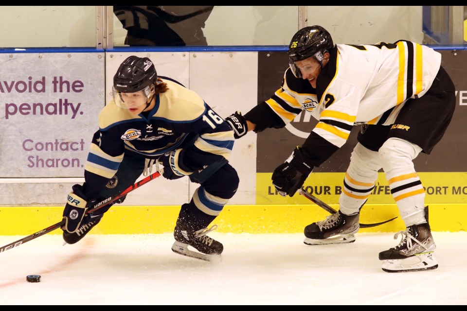  Langley Rivermen forward Owen Kim tries to escape the checking of Coquitlam Express defenceman Lucas Lundy in the first period of their BC Hockey League pre-season game, Wednesday at the Poirier Sport and Leisure Complex.