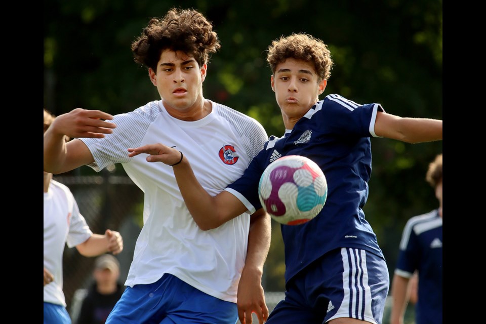 Riverside Rapids' Edoardo De Filippis and Centennial Centaurs Anthony Lopez battle for the ball in the first half of the Fraser North AAA senior boys soccer match, last Thursday at Gates Park in Port Coquitlam. Riverside won, 4-0.