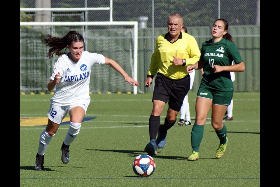Port Coquitilam's Maya Smith chases down a ball for the Capilano University Blues during a recent game against the Douglas Royals.