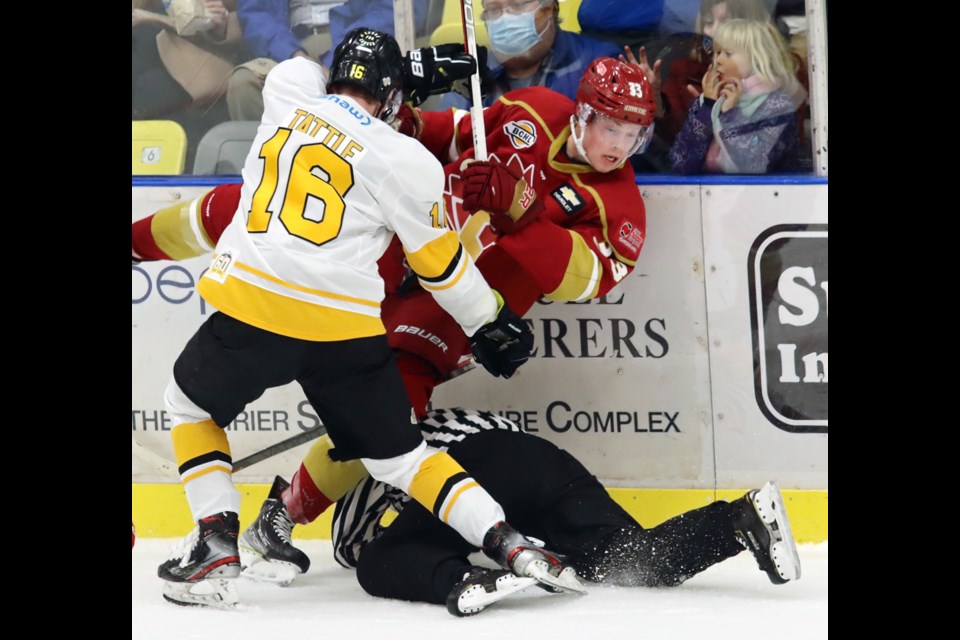 Coquitlam Express forward Ryan Tattle and Kienan Draper of the Chilliwack Chiefs crash into referee Megan Howes in the first period of their BC Hockey League game, Friday at the Poirier Sport and Leisure Complex.