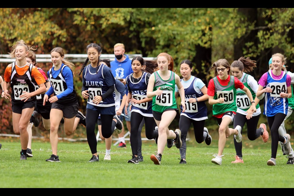 And they're off. The junior girls head out on their four kilometre circuit of Coqutilam's Mundy Park at Thursday's Fraser North District high school cross-country championships.