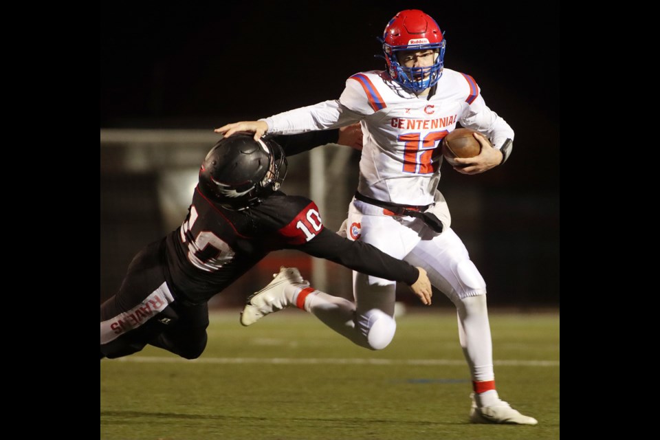 Centennial Centaurs quarterback Malcolm Cameron tries to escape the tackle of Terry Fox Ravens linebacker Alex Gagnon early in the second half of their Coquitlam Cup senior varsity football game, Friday at Percy Perry Stadium.