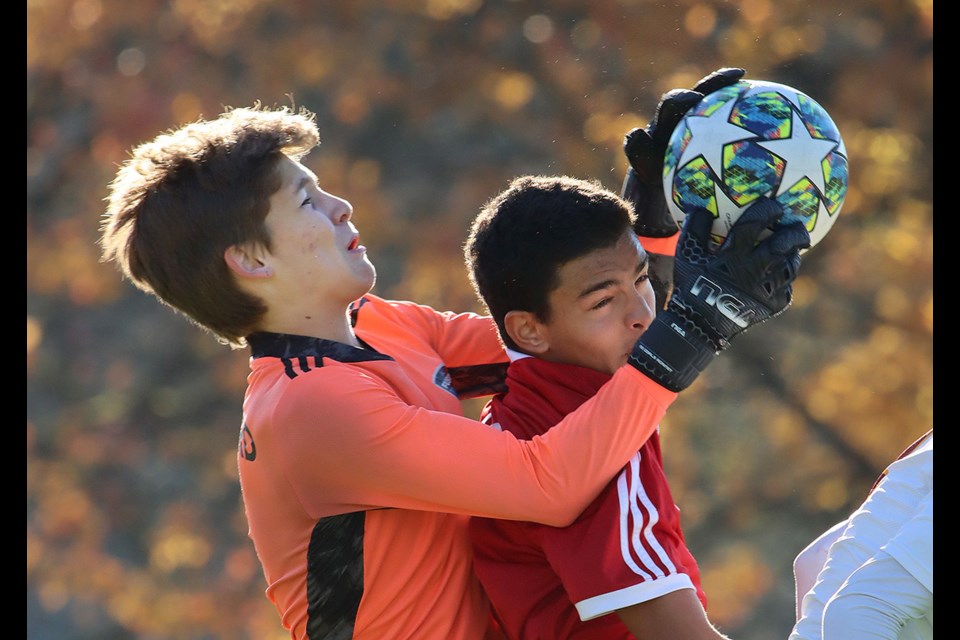 Terry Fox Ravens forward Matthew Marrone tries to get between Burnaby North Vikings goalkeeper Jason Shellard and a save during the first half of their Fraser North AAA boys soccer championship match, last Wednesday at Gates Park in Port Coquitlam. Fox won, 2-1.