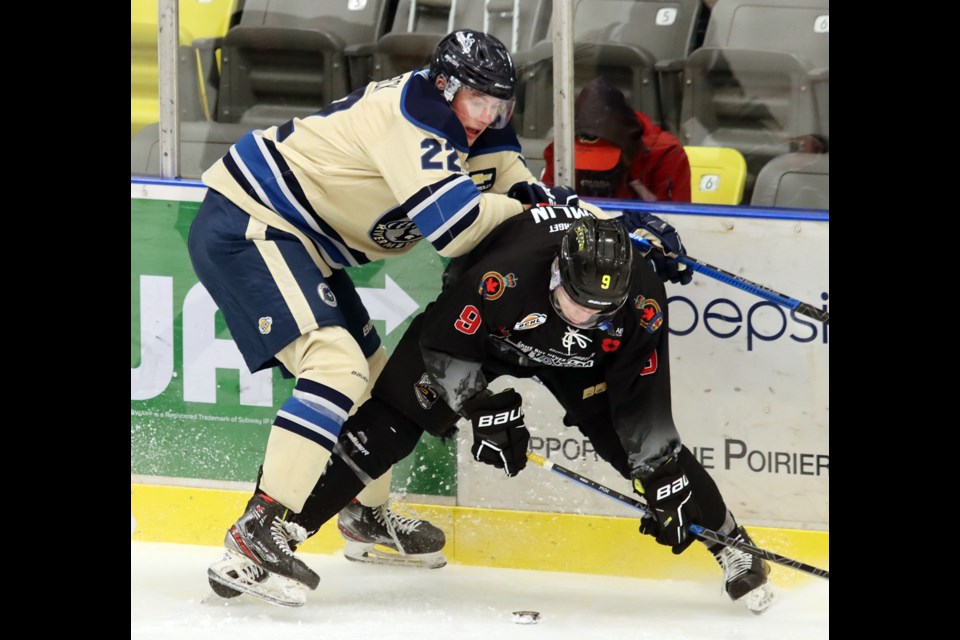 Coquitlam Express forward Ray Hamlin knocks Riley Wallack of the Langley Rivermen off the puck in the first period of their BC Hockey League game, Wednesday at the Poirier Sport and Leisure Complex.