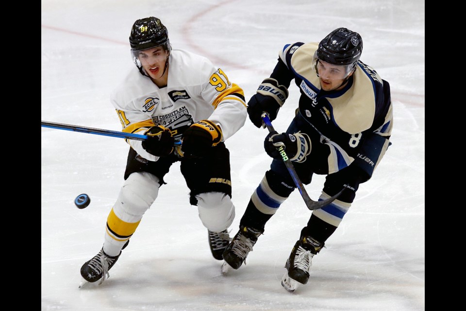 Coquitlam Express forward Reilley Kotai and Langley Rivermen's Deven Nagra keep their eyes on a bouncing puck in the second period of their BC Hockey League game, Friday at the Poirier Sport and Leisure Complex.