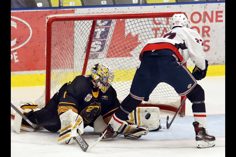 Coquitlam Express goalie Connor Mackenzie makes a pad save on Cowichan Valley Capitals' forward Arjun Bawa in the second period of their BC Hockey League game, Saturday at the Poirier Sport and Leisure Complex.