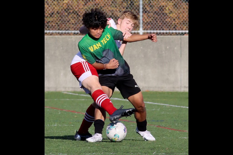 Terry Fox Ravens' forward Owen Watson battles a  Van Tech defender for control of the ball in the first half of their BC High School AAA boys soccer provincials match, last Thursday at the Burnaby Lake Sports Complex West. Fox won the match, 2-0, and went on to finish third in the tournament.