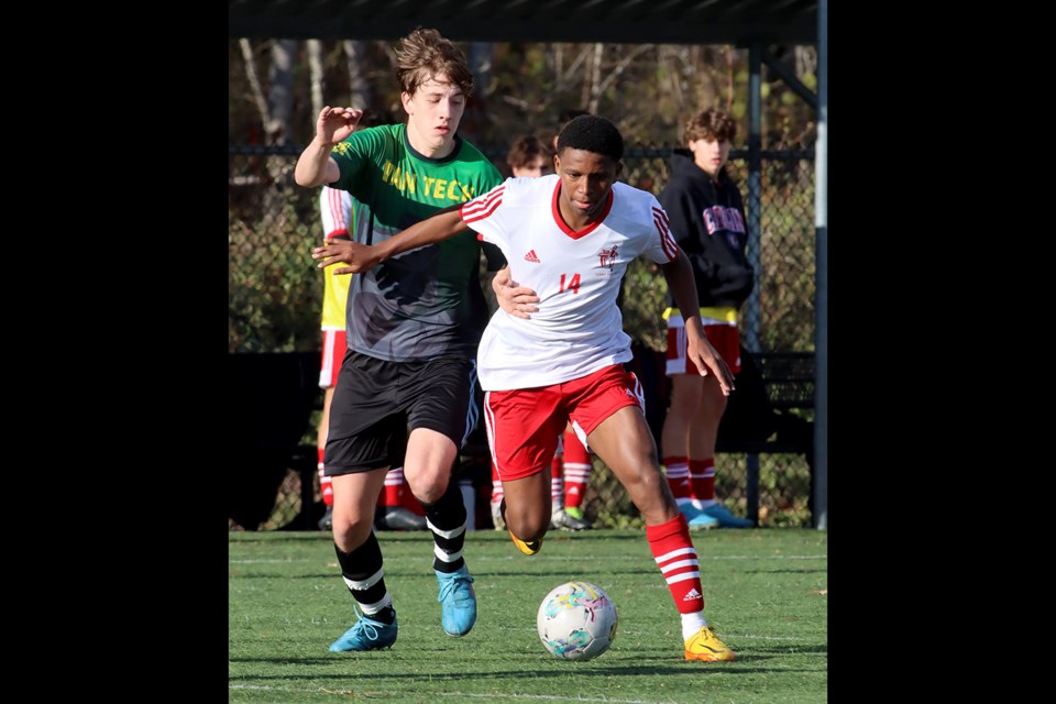 Terry Fox Ravens' forward Jhonatan Vente Barrios battles a  Van Tech defender for control of the ball in the first half of their BC High School AAA boys soccer provincials match, last Thursday at the Burnaby Lake Sports Complex West. Fox won the match, 2-0, and went on to finish third in the tournament.