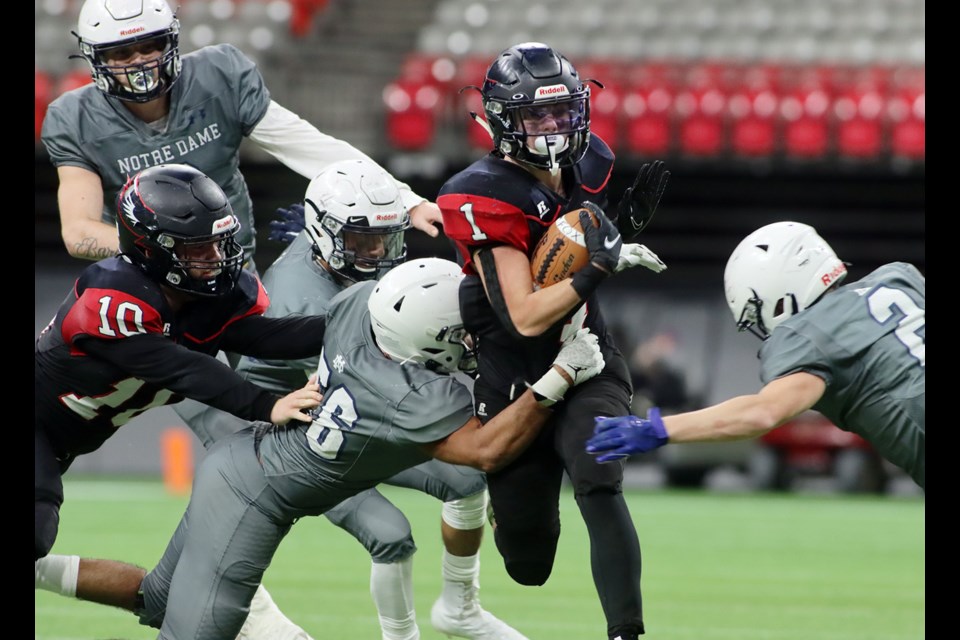 Terry Fox Ravens running back Gavin Whittingham (#1) threads his way through four Notre Dame Jugglers tacklers in the second half of their BC Secondary Schools Football Association Subway Bowl semifinal, Nov. 27, 2021, at BC Place. Fox won the game, 27-12, to advance to next Saturday's championship against Chilliwack's CW Graham Grizzlies.