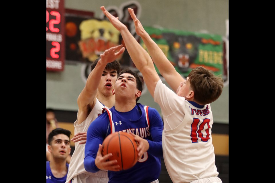 Centennial Centaurs guard Jacob Rodriguez navigates his way through a pair of Semiahmoo Thunderbirds defenders in the first half of their opening game at the Kodiak Klassic senior boys high school basketball tournament, Thursday at Heritage Woods Secondary School in Port Moody. The Centaurs lost, 70-69, while the host Kodiaks also fell, 63-47, to Fleetwood Park. The tournament continues through to Saturday, with the championship final scheduled for 8:45 p.m.